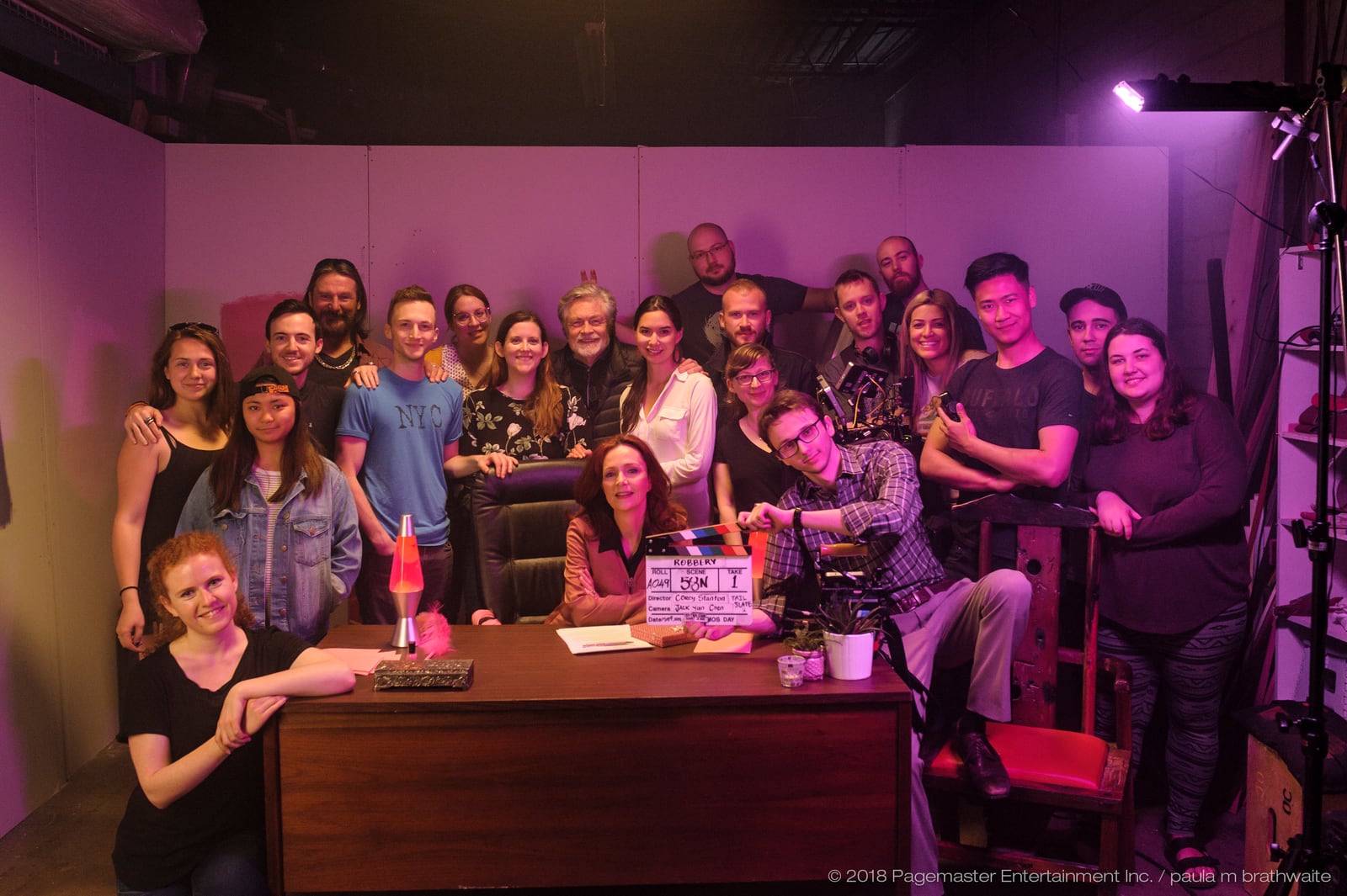 The cast and crew of Robbery gathered on set.